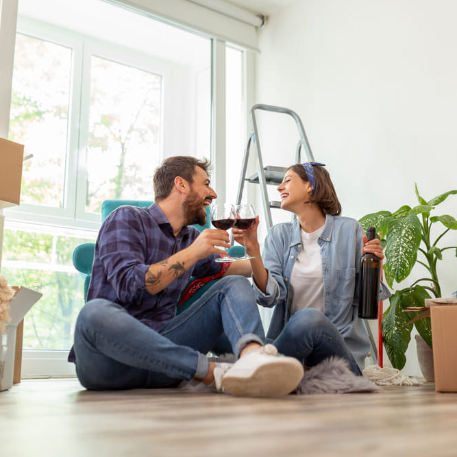couple drinking wine with moving boxes