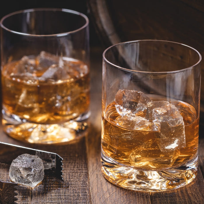 Two rocks glasses of whiskey with ice