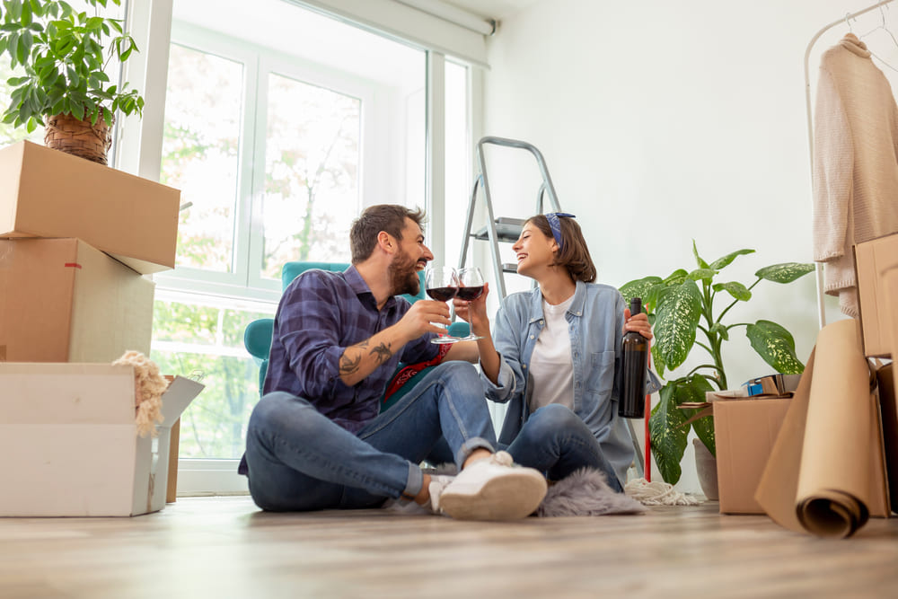 couple drinking wine with moving boxes