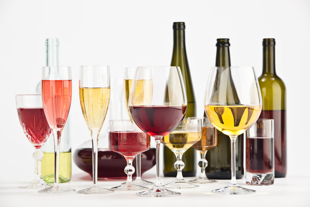 different types of wine glasses aligned on a table