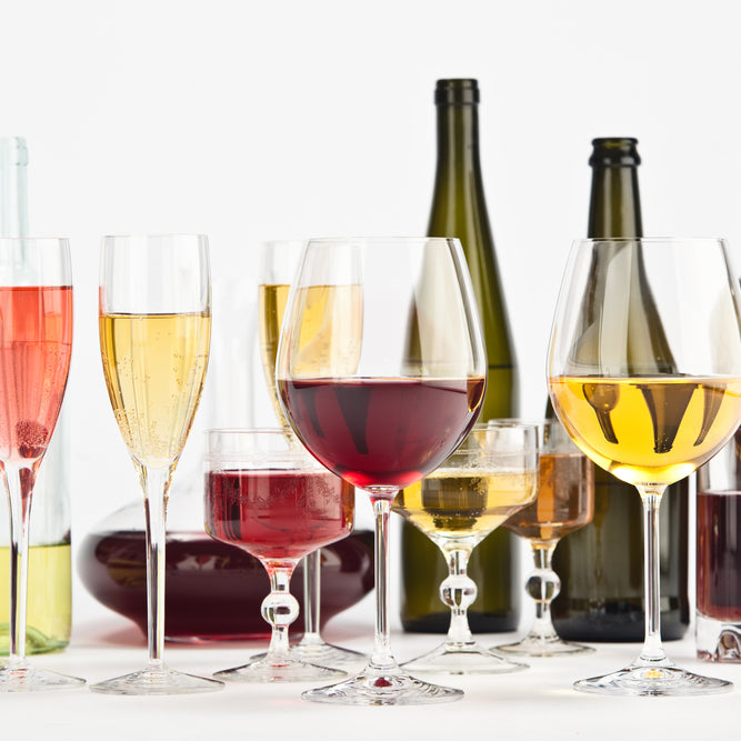different types of wine glasses aligned on a table